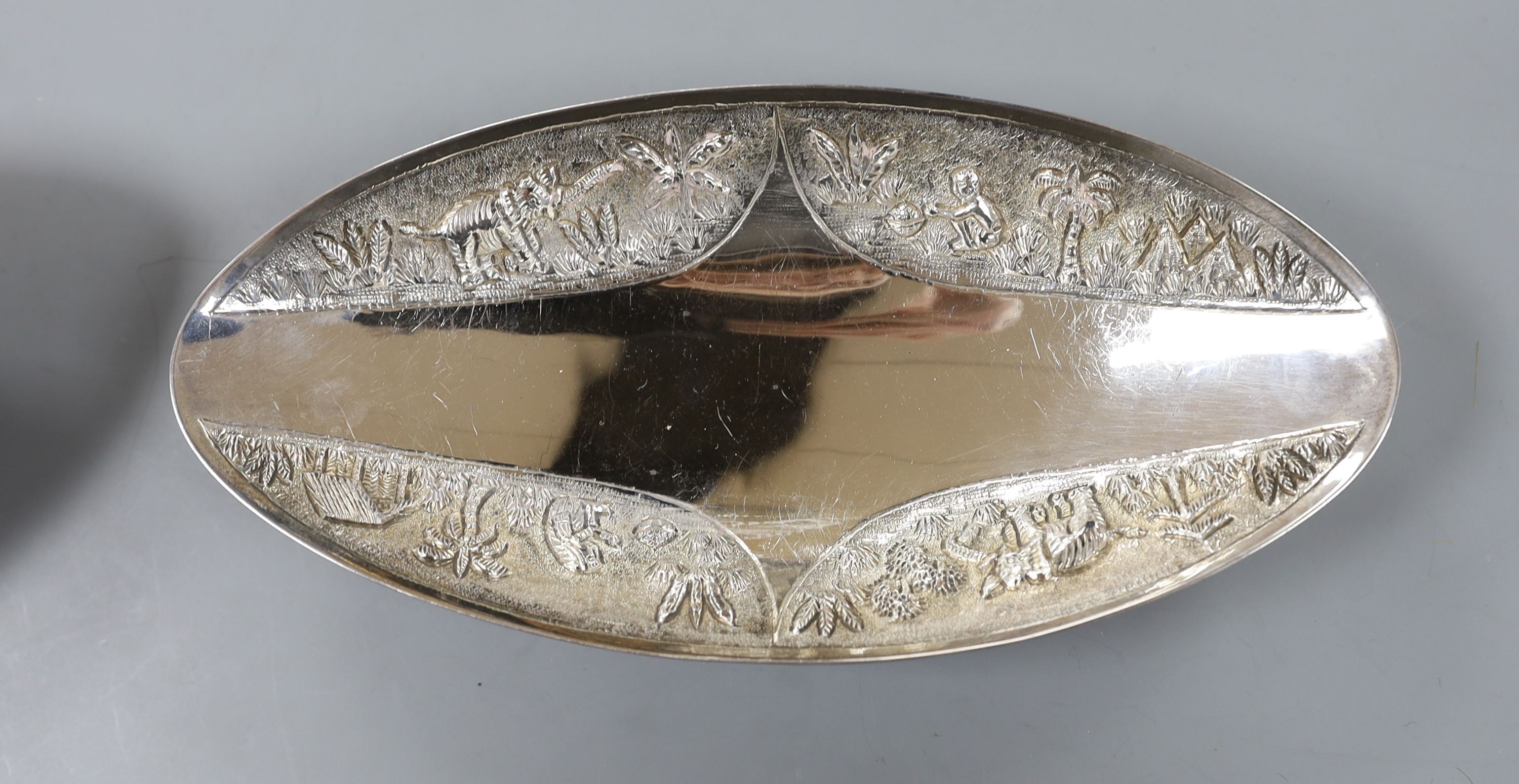 A pair of Indian sterling oval dishes, embossed with figures and elephants, 24.9cm, 18.5oz.